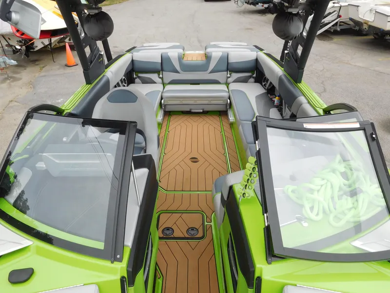 Slide: The Image of 2017 Malibu Wakesetter 24 MXZ interior with green accents and spacious seating. - 43