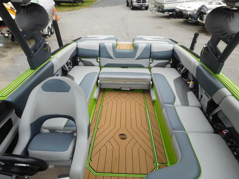 Slide: The Image of 2017 Malibu Wakesetter 24 MXZ interior with gray and green seating, teak flooring. - 44