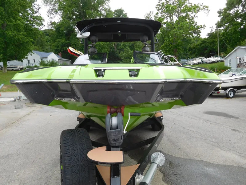 Slide: The Image of 2017 Malibu Wakesetter 24 MXZ in green on a trailer, front view. - 9