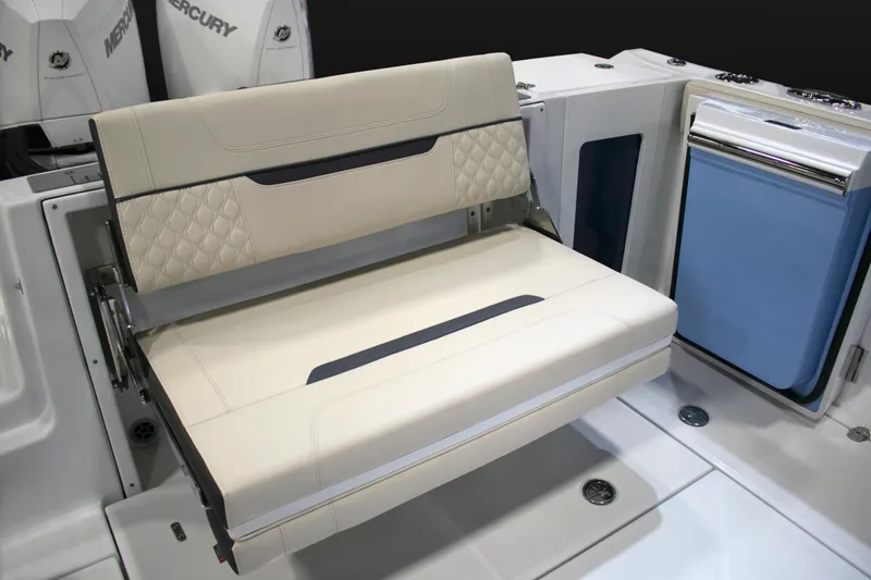 Slide: The Image of 2024 Blackfin 302 DC boat with beige seating and storage compartments. - 6