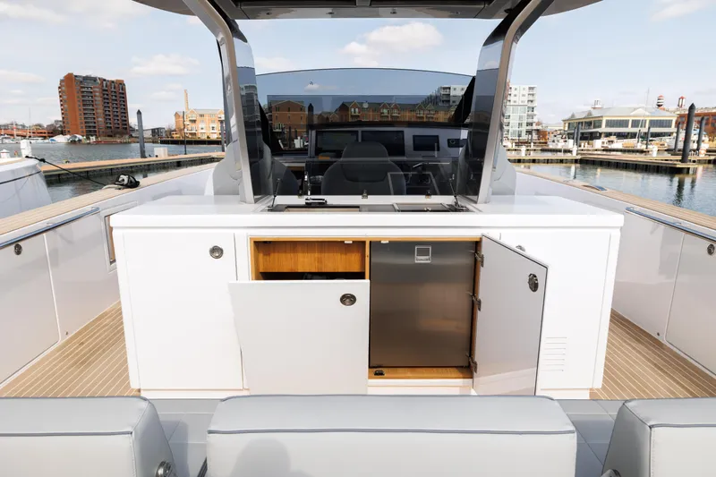 Slide: The Image of 2024 Pardo Yachts 43 deck with open storage compartments and waterfront view. - 21