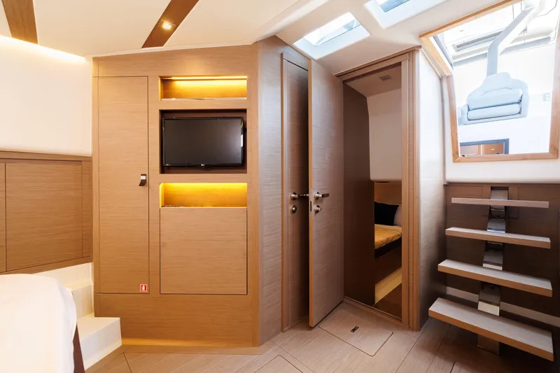 Slide: The Image of Interior of 2024 Pardo Yachts 43, featuring modern wood finishes and built-in TV. - 46