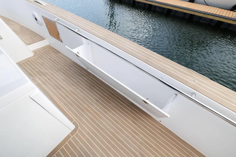 Slide: The Image of 2024 Pardo Yachts 43 deck with wood flooring and storage compartment. - 38