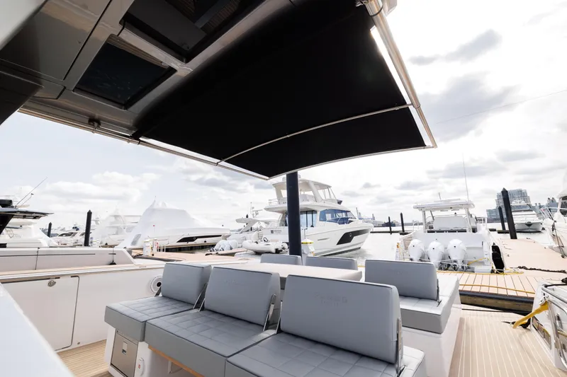Slide: The Image of 2024 Pardo Yachts 43 luxury yacht with shaded seating area at marina. - 42