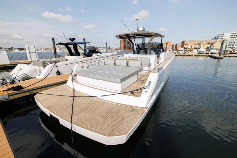 Slide: The Image of 2024 Pardo Yachts 43 docked at a marina, showcasing its spacious deck and modern design. - 6