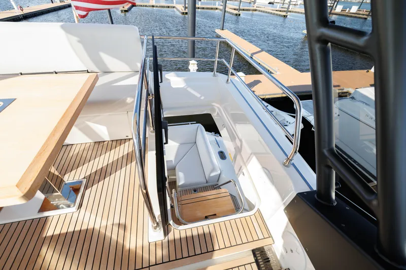 Slide: The Image of 2024 Prestige 520 yacht with teak deck and seating area. - 12