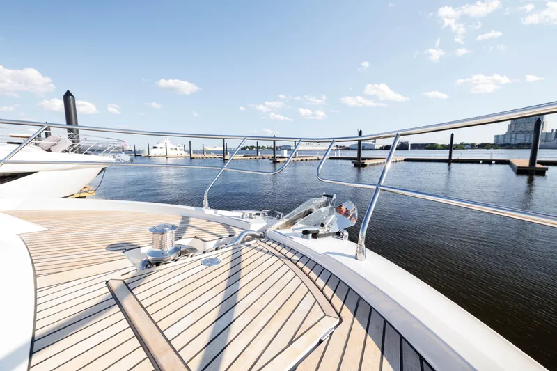 Slide: The Image of Prestige 520 yacht 2024 model, docked at a marina with clear skies and calm waters. - 14