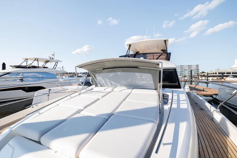 Slide: The Image of 2024 Prestige 520 yacht docked at marina under clear sky. - 15