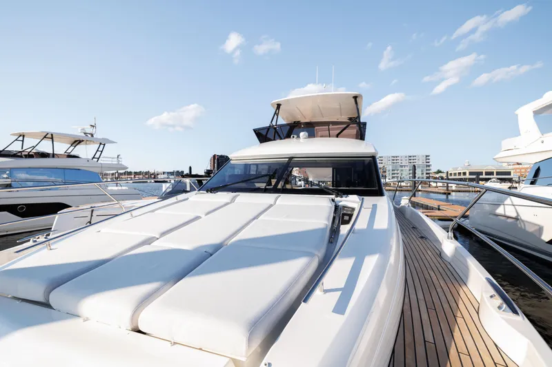 Slide: The Image of 2024 Prestige 520 yacht docked at marina on a sunny day. - 16