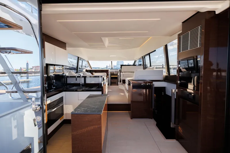 Slide: The Image of Interior of 2024 Prestige 520 yacht with modern kitchen and seating area. - 17
