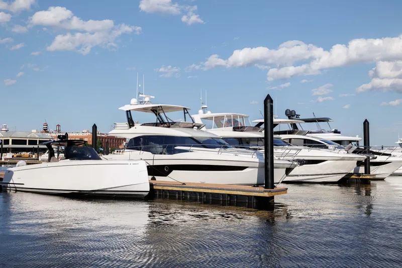 Slide: The Image of Luxury yachts docked at marina, featuring 2024 Prestige 520 model. - 2