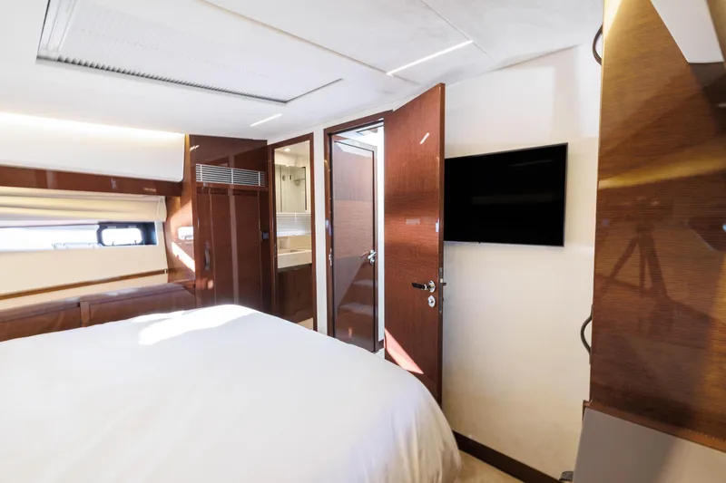 Slide: The Image of Luxurious bedroom on the Prestige 520 yacht, model year 2026. - 29