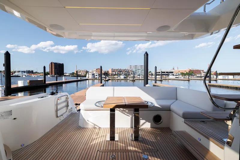 Slide: The Image of 2024 Prestige 520 yacht with spacious deck and waterfront view. - 4