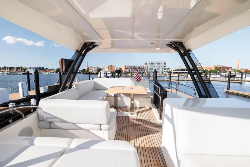 Slide: The Image of 2024 Prestige 520 yacht with spacious deck and waterfront view. - 8