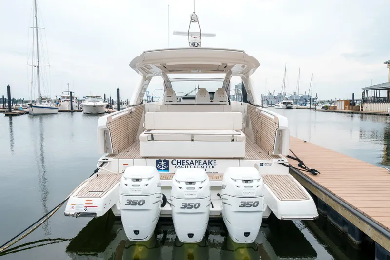 Slide: The Image of 2024 Jeanneau DB|43 Outboard boat with triple 350 engines at marina dock. - 14