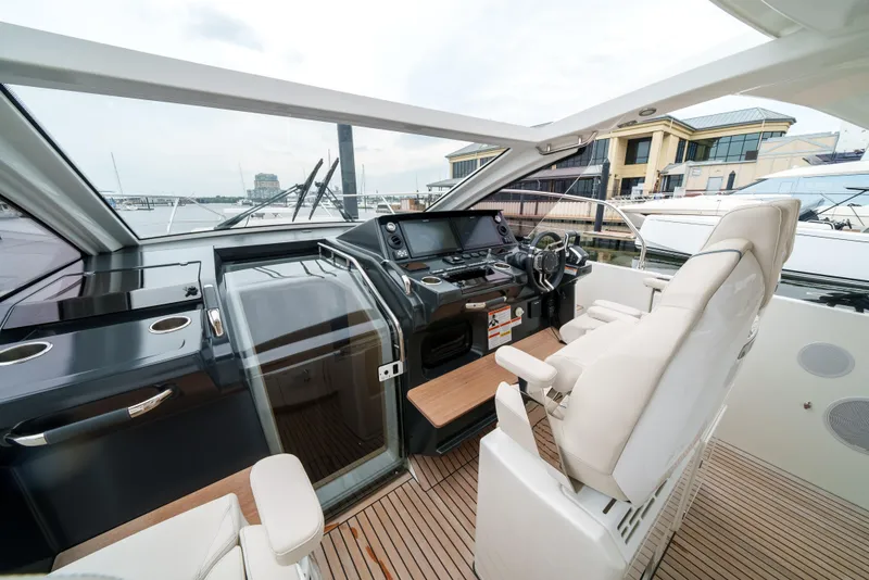 Slide: The Image of 2024 Jeanneau DB|43 Outboard cockpit with modern controls and luxurious seating. - 18