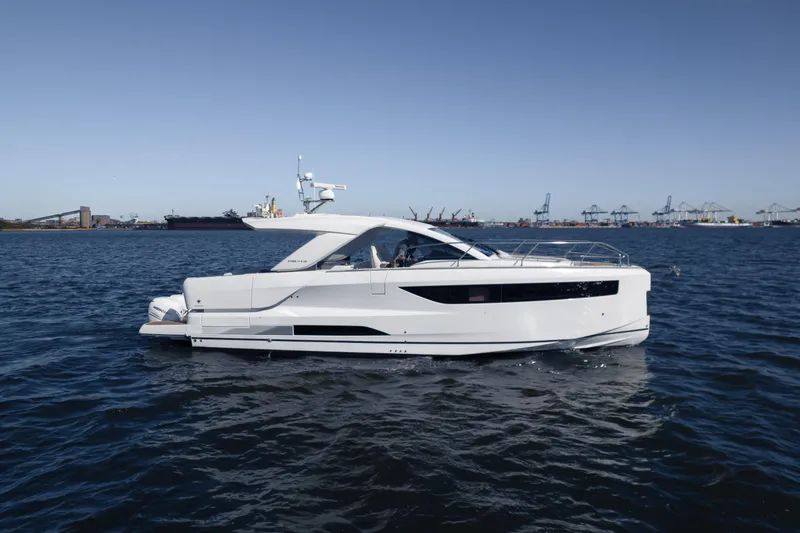 Slide: The Image of 2024 Jeanneau DB|43 Outboard yacht cruising on open water. - 2