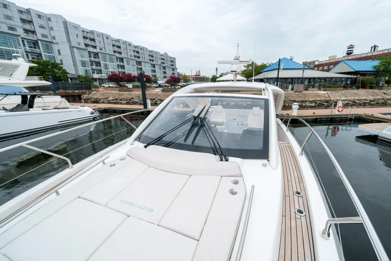 Slide: The Image of 2024 Jeanneau DB|43 Outboard yacht docked at marina, modern design. - 24