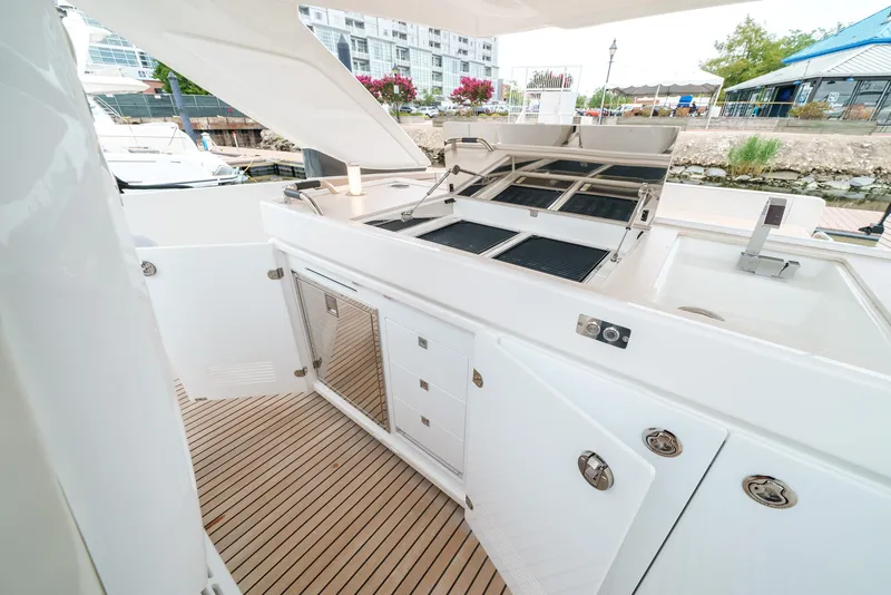 Slide: The Image of 2024 Jeanneau DB|43 Outboard boat deck with grill and storage cabinets. - 31
