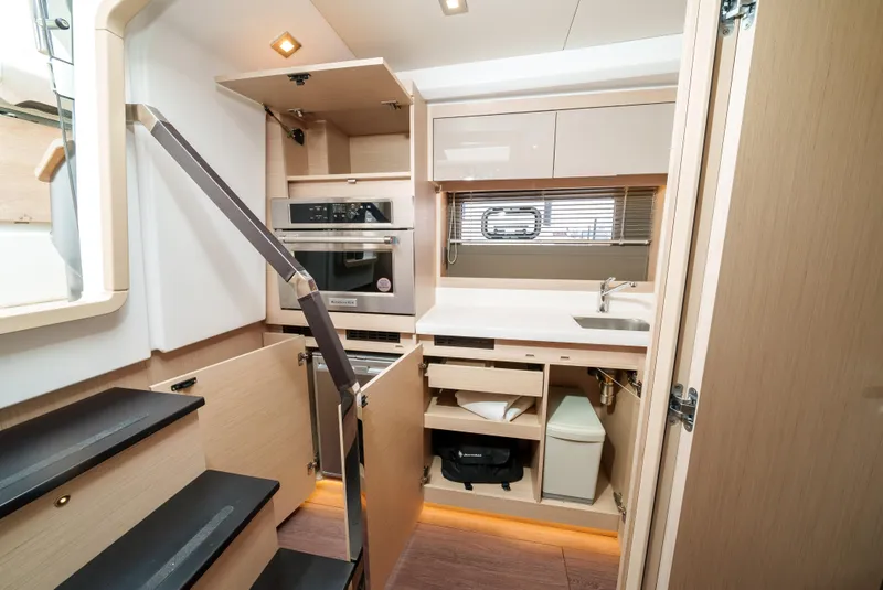 Slide: The Image of 2024 Jeanneau DB|43 Outboard interior kitchen with modern appliances and sleek design. - 35
