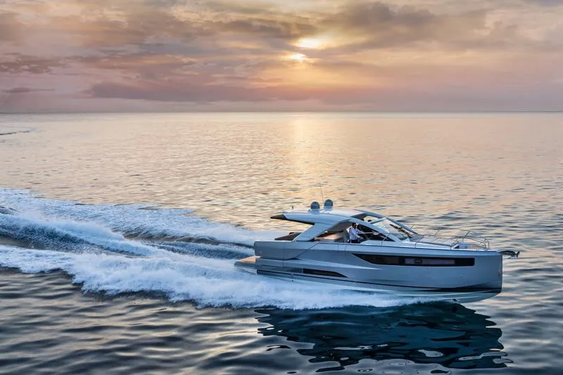Slide: The Image of 2025 Jeanneau DB|43 Inboard yacht cruising at sunset on calm waters. - 17