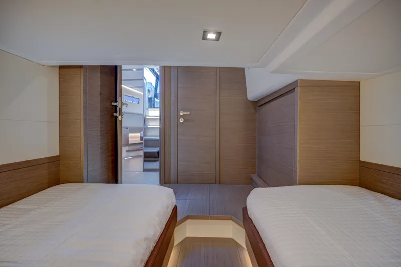 Slide: The Image of Modern cabin interior of 2025 Pardo Yachts 50 with twin beds and wooden finishes. - 16
