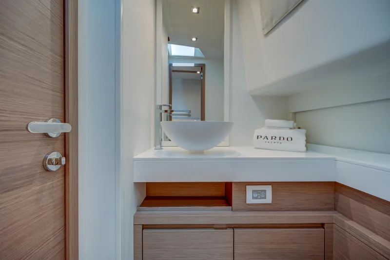 Slide: The Image of Modern bathroom on the 2025 Pardo Yachts 50, featuring sleek sink and wooden cabinetry. - 17