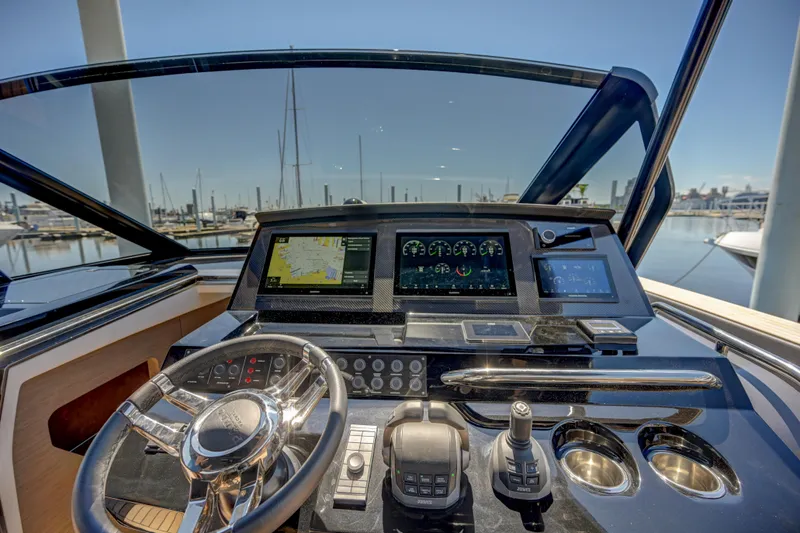 Slide: The Image of Helm of 2025 Pardo Yachts 50 with advanced navigation systems and marina view. - 27