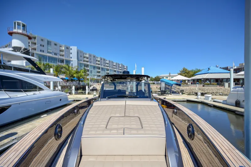 Slide: The Image of 2025 Pardo Yachts 50 docked at a marina with modern buildings in the background. - 29