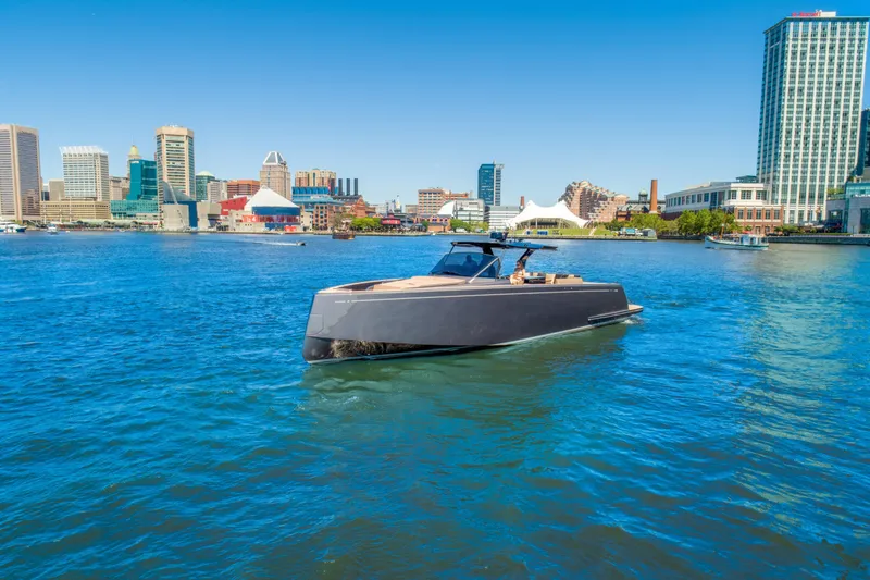 Slide: The Image of 2025 Pardo Yachts 50 cruising in a vibrant city harbor. - 7