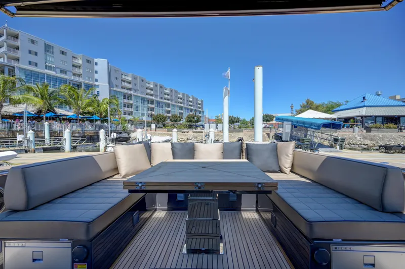Slide: The Image of Luxury seating area on the 2025 Pardo Yachts 50, docked at a marina. - 19