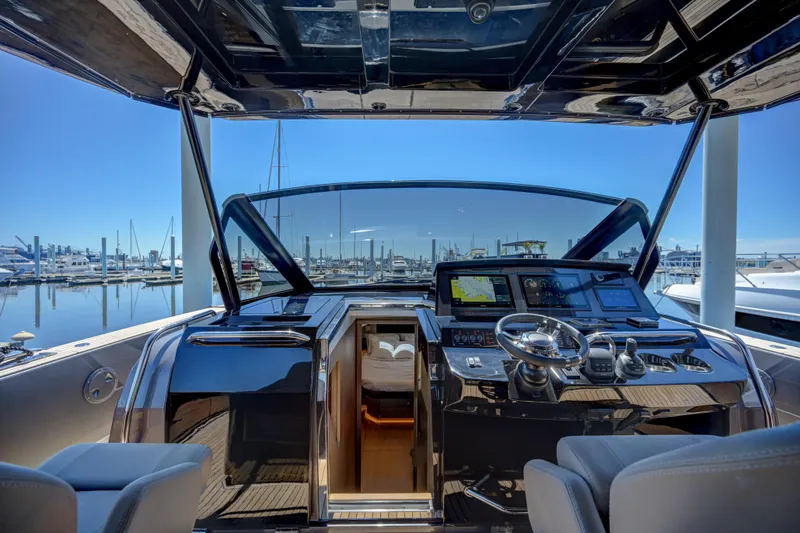 Slide: The Image of Cockpit view of 2025 Pardo Yachts 50 at marina, featuring modern navigation equipment. - 28