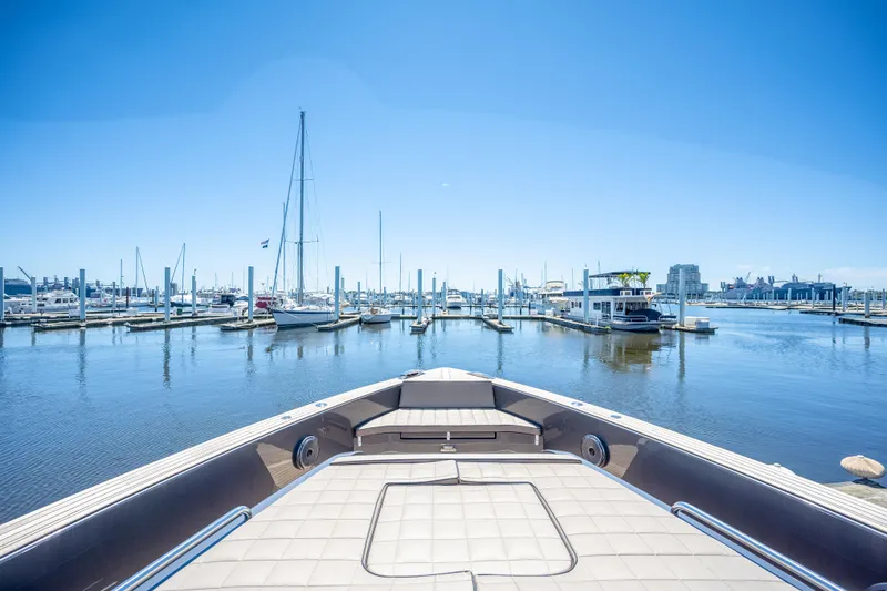Slide: The Image of Bow view of 2025 Pardo Yachts 50 in a marina with clear blue sky. - 30