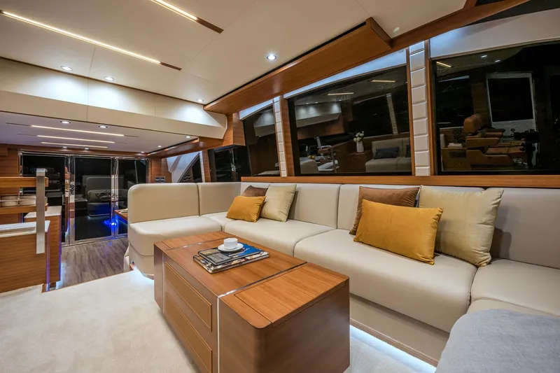 Slide: The Image of Luxurious interior of 2025 Dyna 63 yacht with modern furnishings and ample seating. - 14