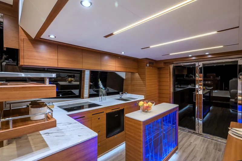 Slide: The Image of Modern kitchen interior on 2025 Dyna 63 yacht with sleek wood finishes and LED lighting. - 24