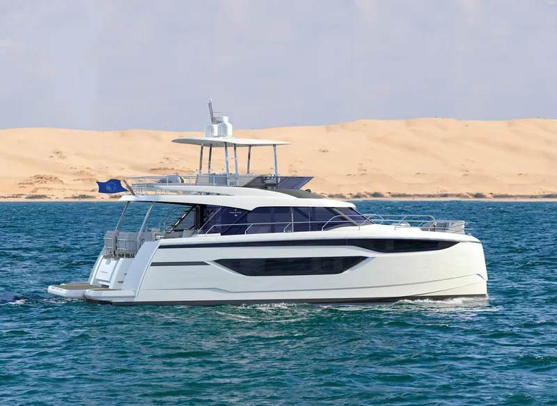 The Image of 2025 Prestige M48 yacht cruising on the ocean with sandy dunes in the background. - 0