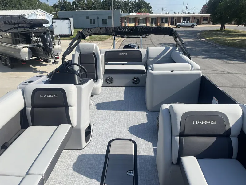 Slide: The Image of 2025 Harris Cruiser 250 pontoon boat with spacious seating and modern design. - 1