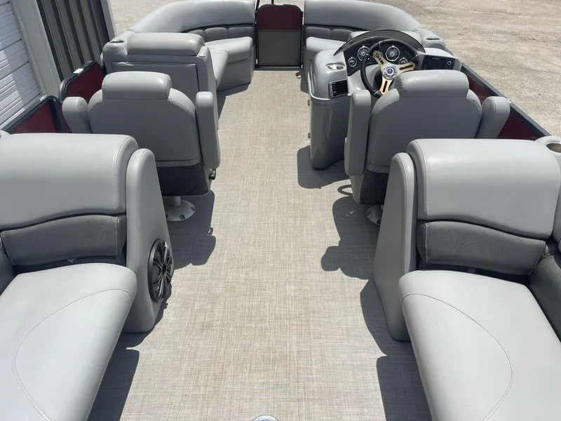 Slide: The Image of 2016 Misty Harbor Biscayne Bay CU 2285 pontoon boat interior with gray seating and steering console. - 13