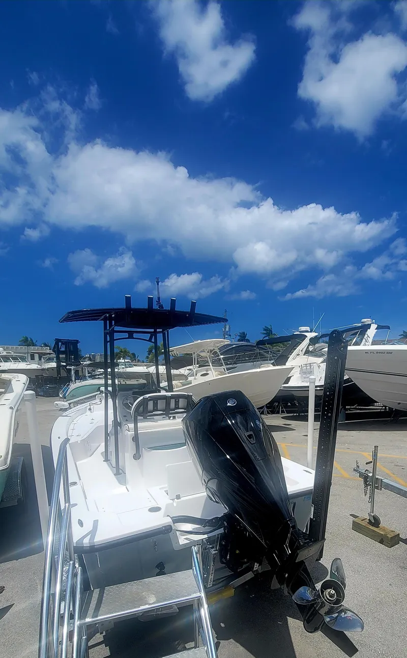 Slide: The Image of 2025 Piranha Casador B2200 boat with outboard motor under a clear blue sky. - 4