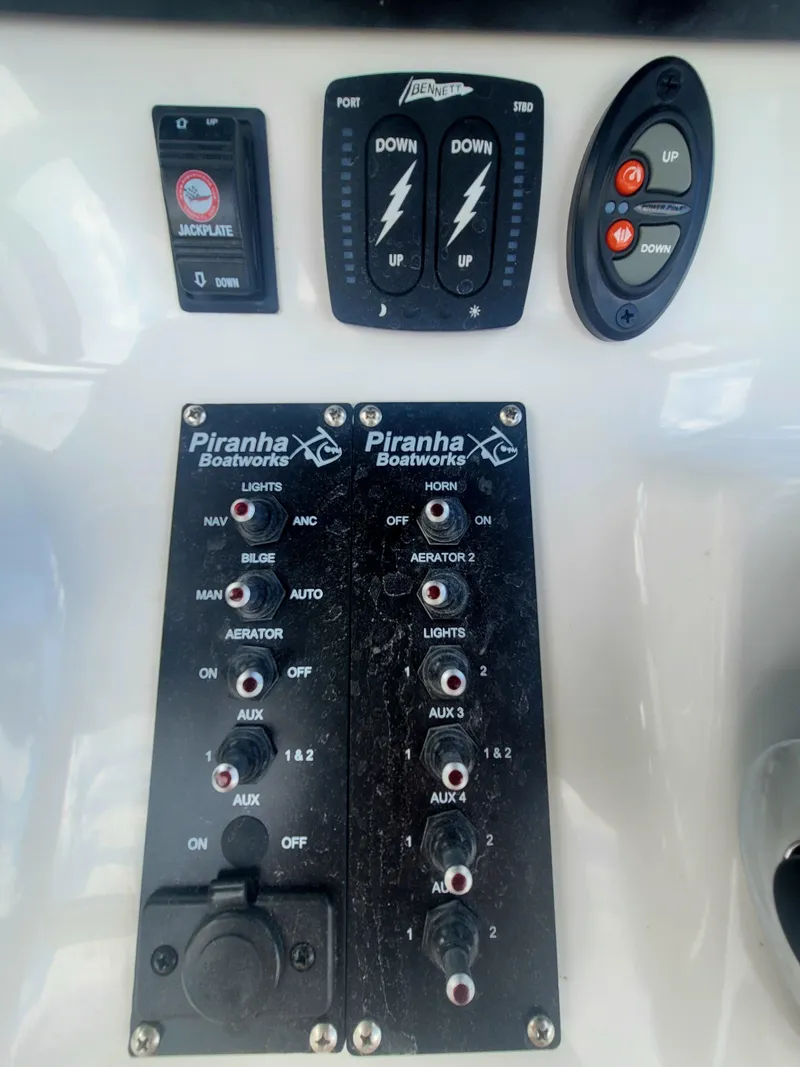 Slide: The Image of Control panel of a 2025 Piranha Casador B2200 boat with various switches and buttons. - 8