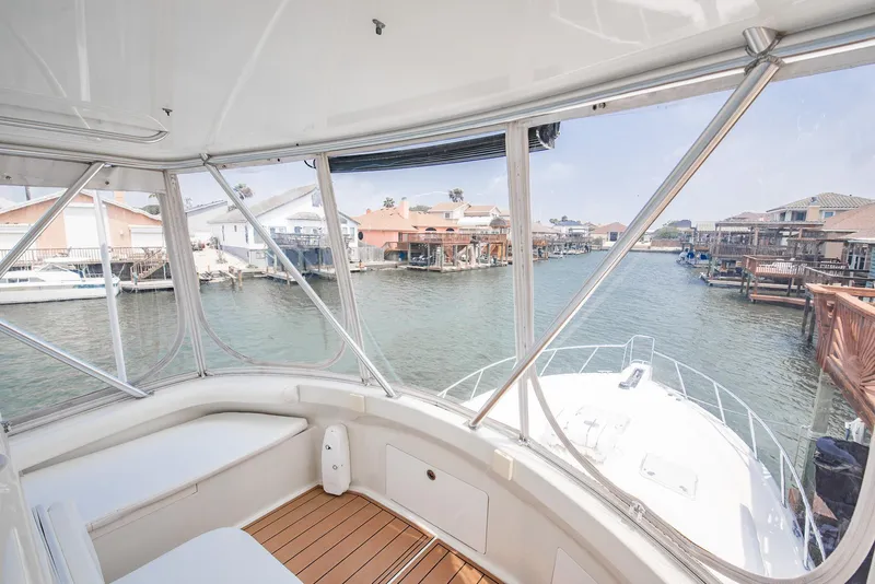 Slide: The Image of View from 2002 Cabo Convertible Painted boat, overlooking waterfront homes and docks. - 11