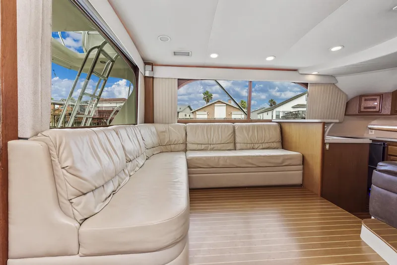 Slide: The Image of Interior of a 2002 Cabo Convertible Painted yacht with beige leather seating. - 15