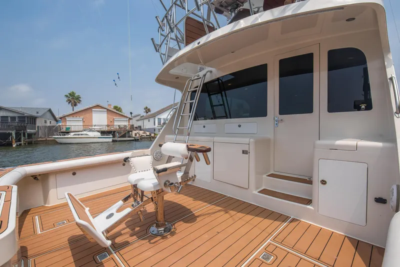 Slide: The Image of 2002 Cabo Convertible Painted boat with teak deck and fishing chair. - 3