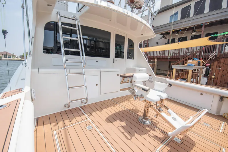 Slide: The Image of 2002 Cabo Convertible Painted boat with teak deck and fishing chair. - 4