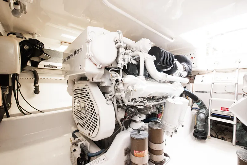 Slide: The Image of 2002 Cabo Convertible Painted engine room with a well-maintained diesel engine. - 47