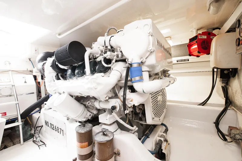 Slide: The Image of 2002 Cabo Convertible Painted engine room with white machinery and equipment. - 48