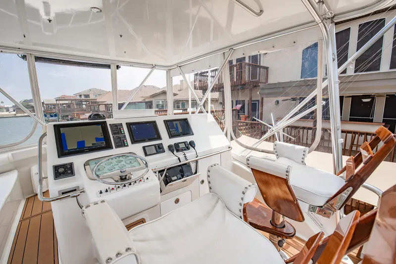 Slide: The Image of 2002 Cabo Convertible Painted boat helm with modern navigation equipment. - 8