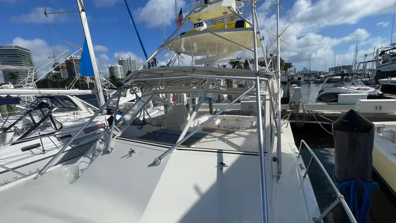 Slide: The Image of 1985 Hatteras 36 Convertible yacht docked at a marina on a sunny day. - 23