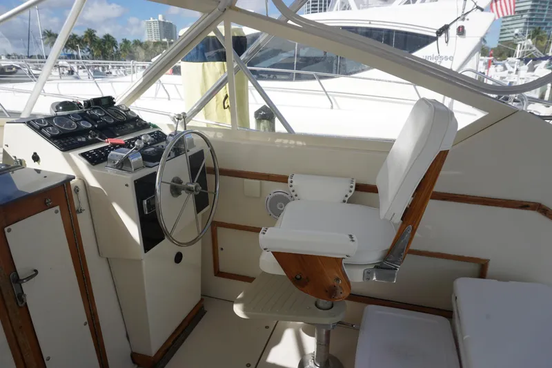Slide: The Image of Captain's chair and helm of a 1985 Hatteras 36 Convertible yacht. - 27