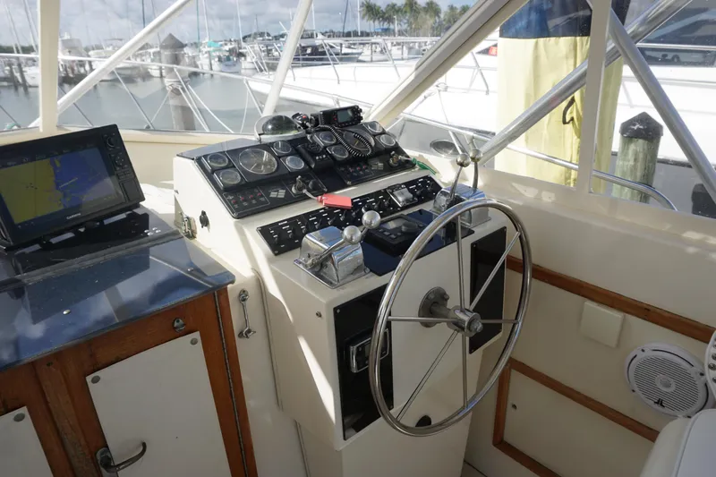 Slide: The Image of Helm of 1985 Hatteras 36 Convertible yacht with navigation equipment and steering wheel. - 28